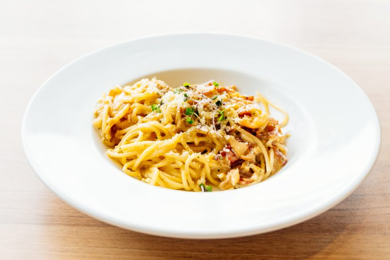 Spaghetti carbonara with ham in white plate - Italian food style